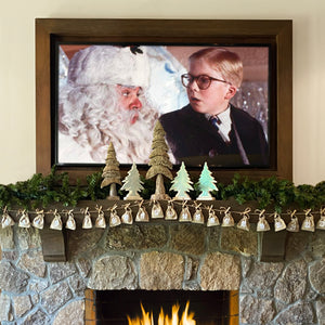 Modern Christmas puzzle in Advent Calendar pouches strung as garland on the mantle